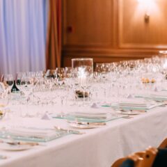 Spacious meeting room at The Atlantic Hotel with rows of chairs, an elegant table, large windows, and modern lighting.