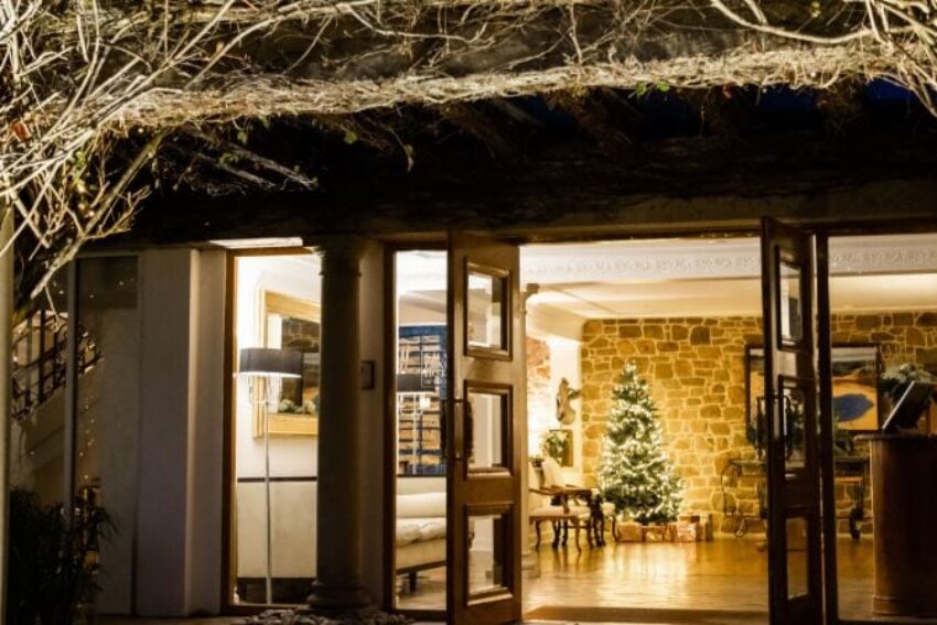 The grand entrance at The Atlantic Hotel in the festive period with fairy lights and a Christmas tree in the hotel lobby.