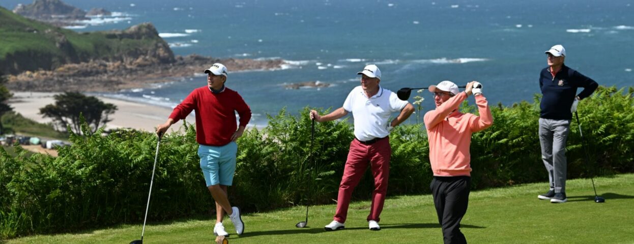 A golfer mid-swing on a sunny day at The Atlantic Hotel